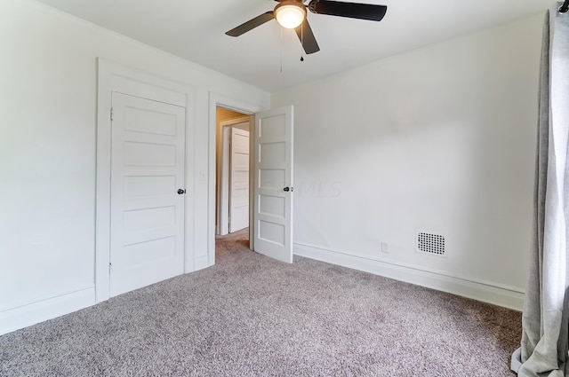 interior space featuring ceiling fan and carpet