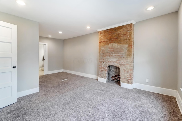 unfurnished living room featuring carpet flooring and a fireplace