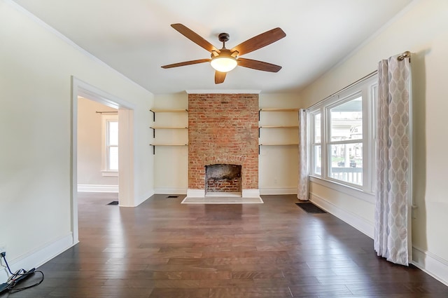 unfurnished living room featuring ceiling fan, dark hardwood / wood-style floors, and a brick fireplace