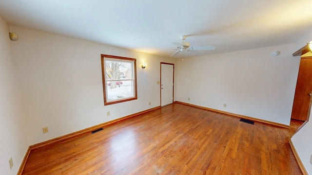 unfurnished room with ceiling fan and wood-type flooring