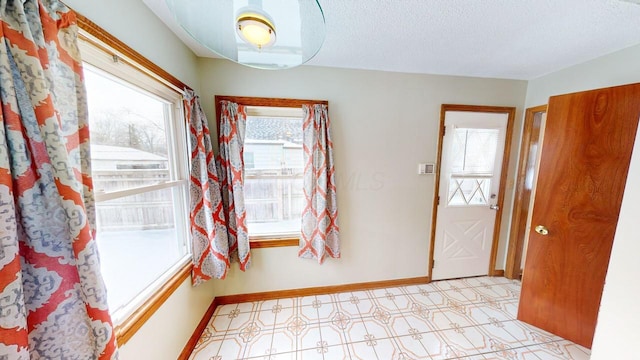 entryway featuring a textured ceiling