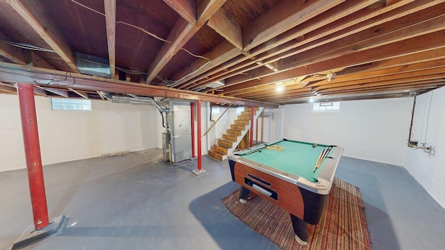 basement featuring pool table and heating unit