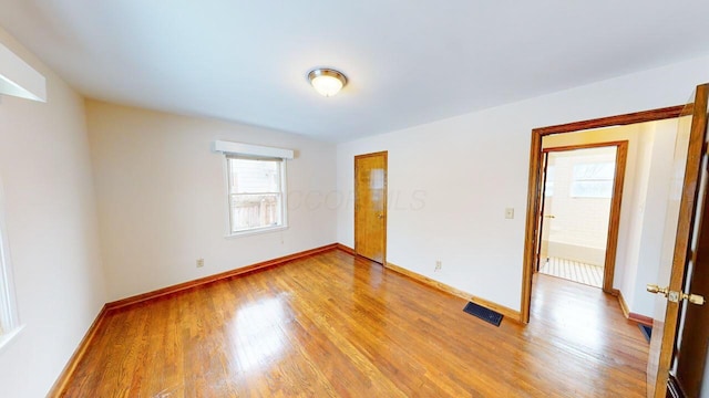 unfurnished room with light hardwood / wood-style flooring