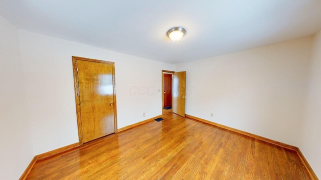 spare room featuring light hardwood / wood-style floors