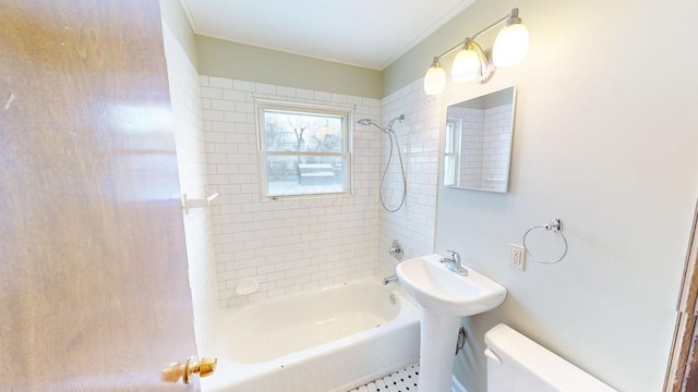 full bathroom with toilet, tiled shower / bath combo, and sink