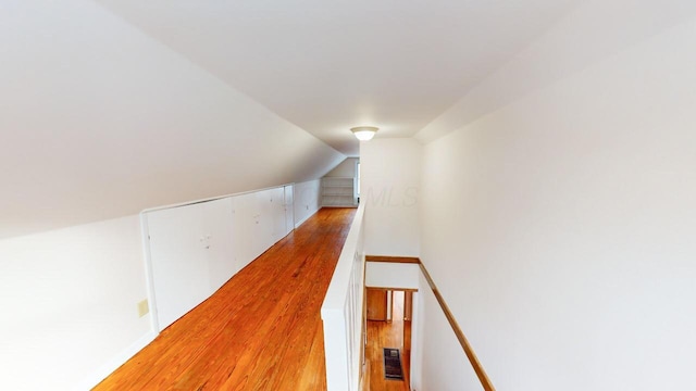 interior space with hardwood / wood-style floors and vaulted ceiling