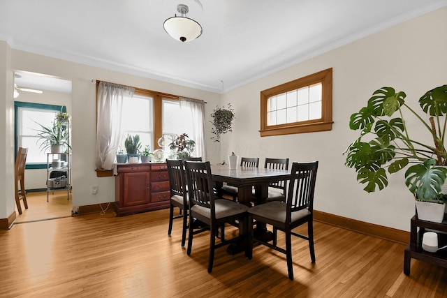 dining room featuring light hardwood / wood-style floors and ornamental molding