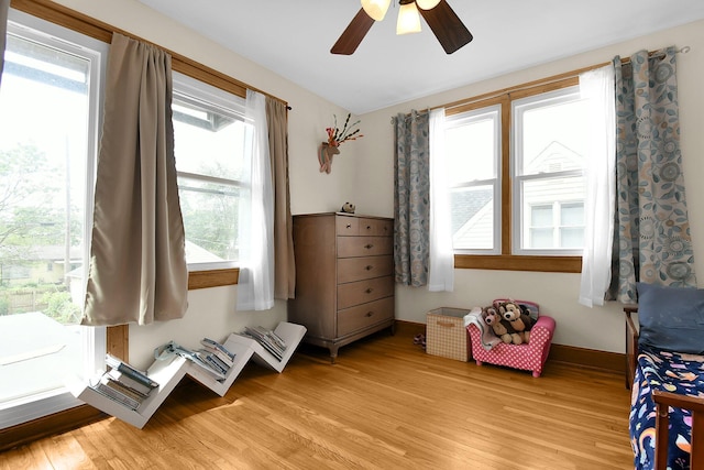 bedroom with ceiling fan and light hardwood / wood-style floors