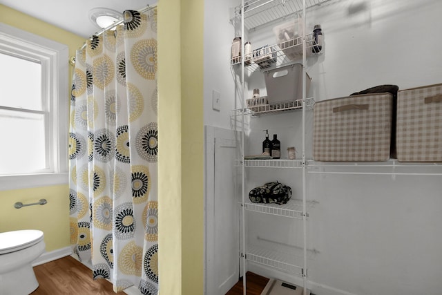 bathroom featuring hardwood / wood-style floors and toilet