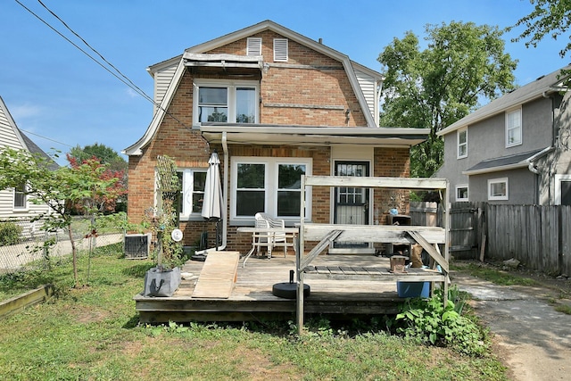 rear view of house featuring cooling unit and a deck