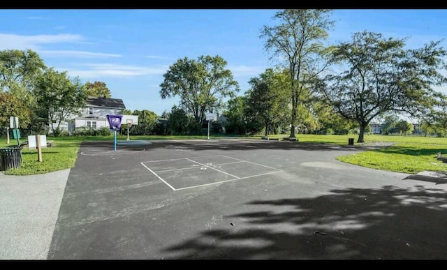 exterior space featuring basketball court and a lawn