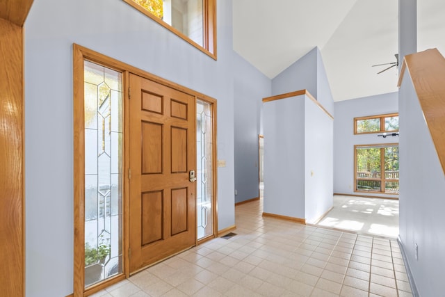 entryway featuring ceiling fan and high vaulted ceiling