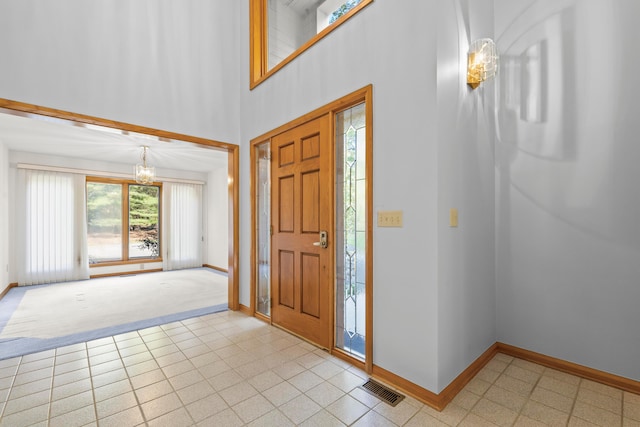 foyer entrance featuring a chandelier and a high ceiling