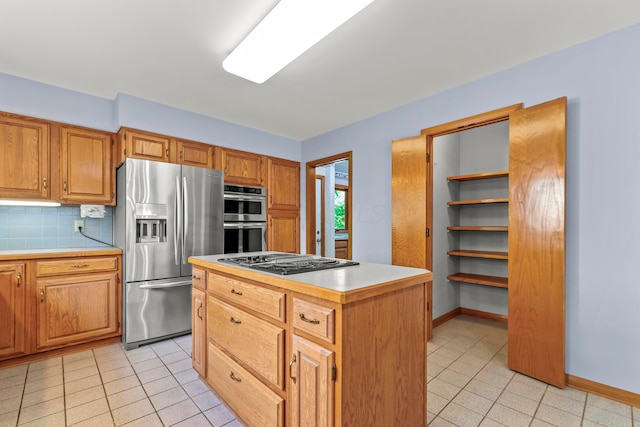 kitchen featuring light tile patterned flooring, decorative backsplash, a kitchen island, and stainless steel appliances