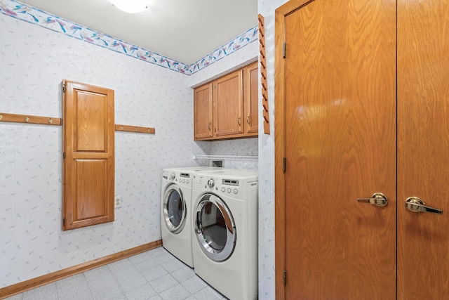 washroom featuring washer and dryer, cabinets, and light tile patterned floors