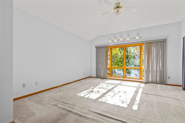 carpeted empty room featuring ceiling fan and lofted ceiling