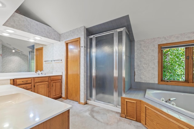 bathroom featuring plus walk in shower, vanity, and lofted ceiling