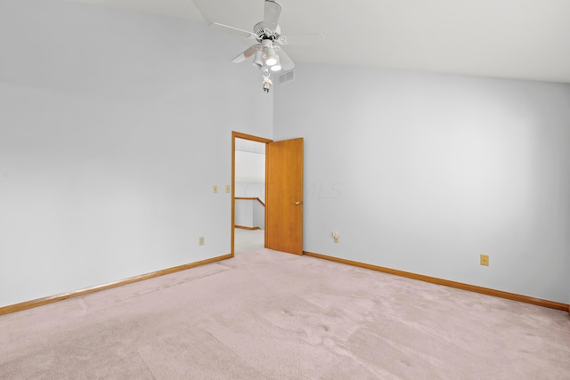 carpeted empty room featuring ceiling fan and lofted ceiling