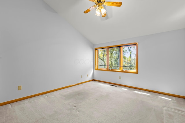 empty room featuring carpet flooring, ceiling fan, and lofted ceiling