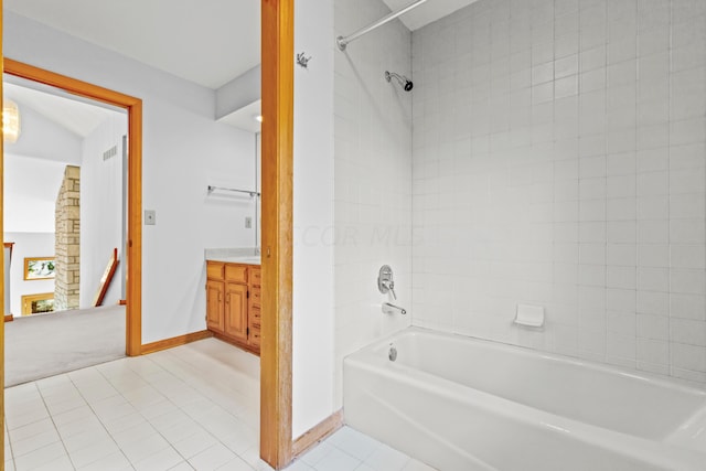 bathroom featuring vanity, tile patterned floors, and tiled shower / bath