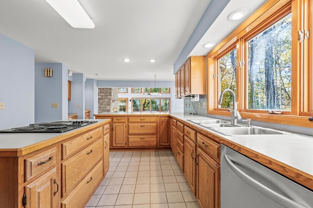 kitchen featuring decorative backsplash, stainless steel appliances, a wealth of natural light, and sink