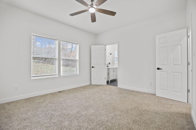 unfurnished bedroom with ensuite bathroom and ceiling fan