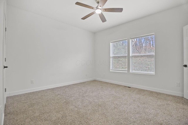 unfurnished room featuring ceiling fan and carpet floors