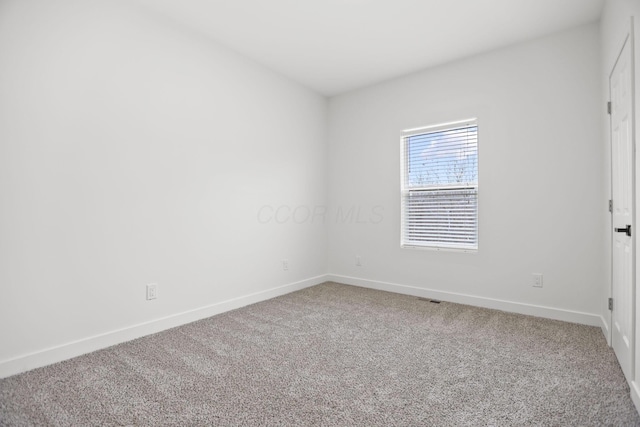 spare room featuring carpet floors