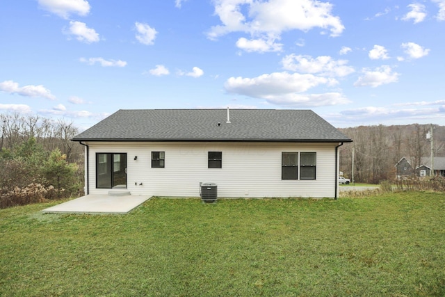 rear view of house featuring a patio, cooling unit, and a lawn