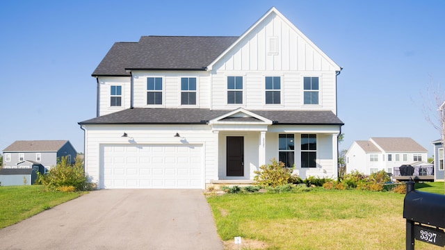 view of front facade with a front yard and a garage