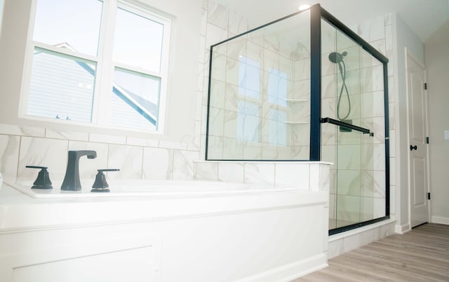 bathroom with hardwood / wood-style floors and a shower with door