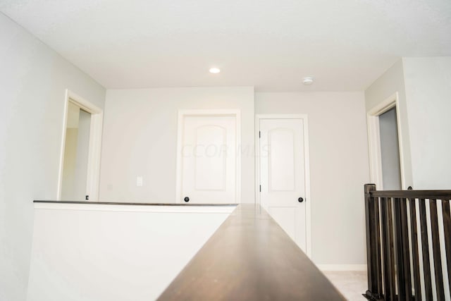 hallway with a textured ceiling