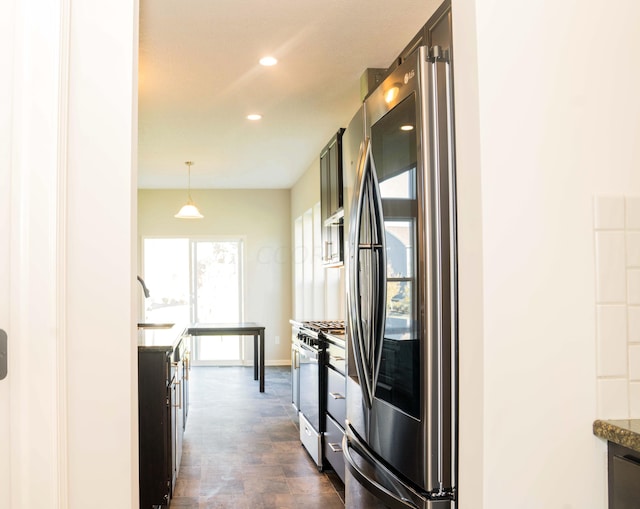 kitchen featuring dark hardwood / wood-style floors, sink, stainless steel appliances, and decorative light fixtures