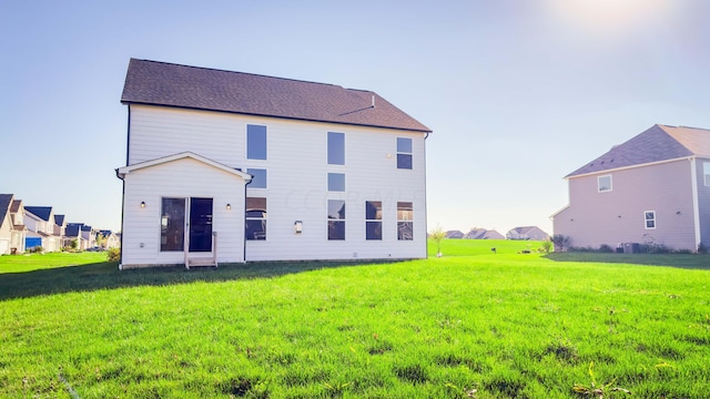 rear view of house featuring a yard