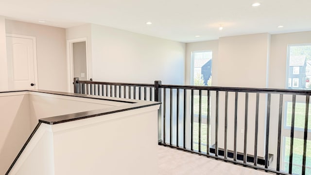 corridor with light colored carpet and plenty of natural light