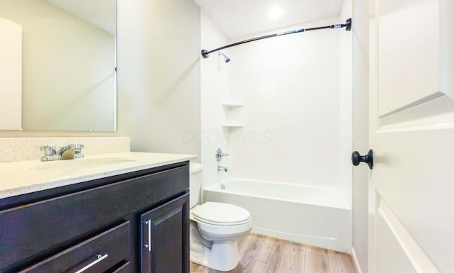 full bathroom with hardwood / wood-style flooring, vanity, toilet, and shower / washtub combination