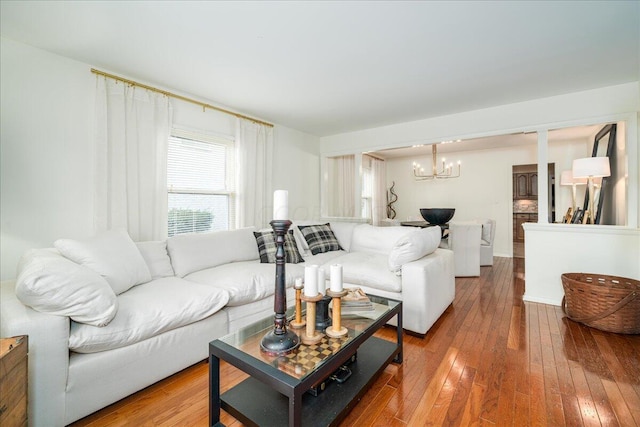 living room featuring hardwood / wood-style floors and an inviting chandelier