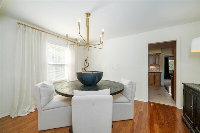 dining area with hardwood / wood-style floors and a chandelier