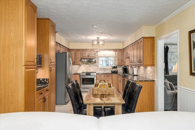 kitchen featuring decorative backsplash, crown molding, sink, and appliances with stainless steel finishes