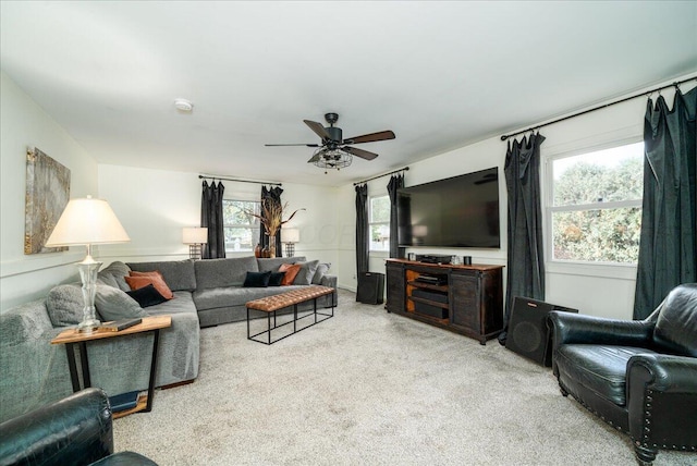 carpeted living room with ceiling fan and a healthy amount of sunlight