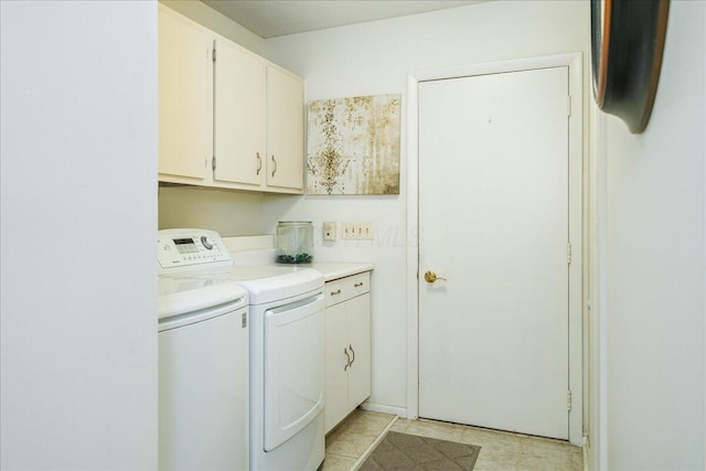 laundry room featuring washer and dryer and cabinets