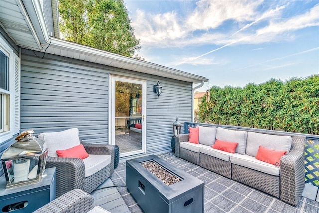 wooden deck with an outdoor living space with a fire pit