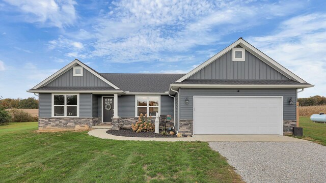 craftsman house with a front yard and a garage