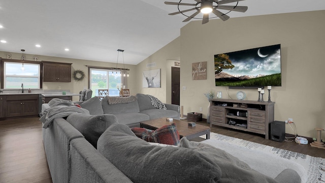 living room featuring a healthy amount of sunlight, sink, ceiling fan, and dark wood-type flooring