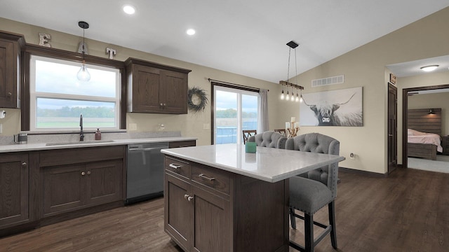 kitchen with dishwasher, sink, dark hardwood / wood-style flooring, decorative light fixtures, and lofted ceiling