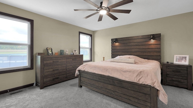 bedroom featuring ceiling fan and light carpet