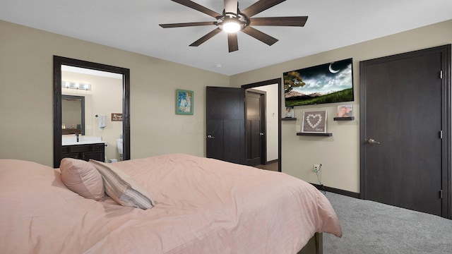 bedroom with carpet flooring, ceiling fan, and connected bathroom