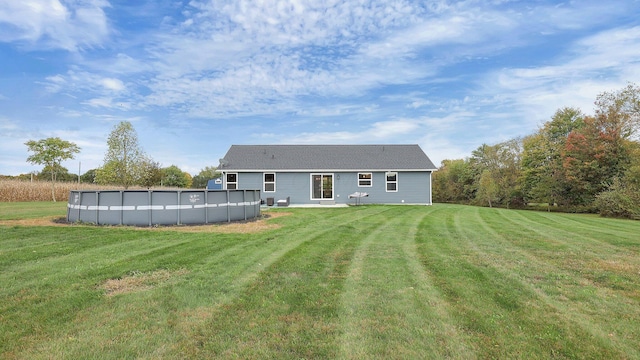 back of property featuring a lawn