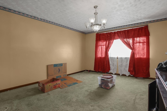 interior space with carpet, a textured ceiling, and an inviting chandelier