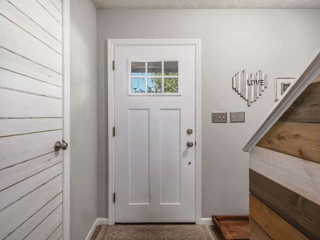 entryway featuring a textured ceiling